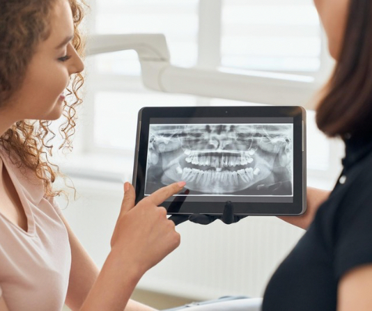 Dentist showing x-rays to a patient.